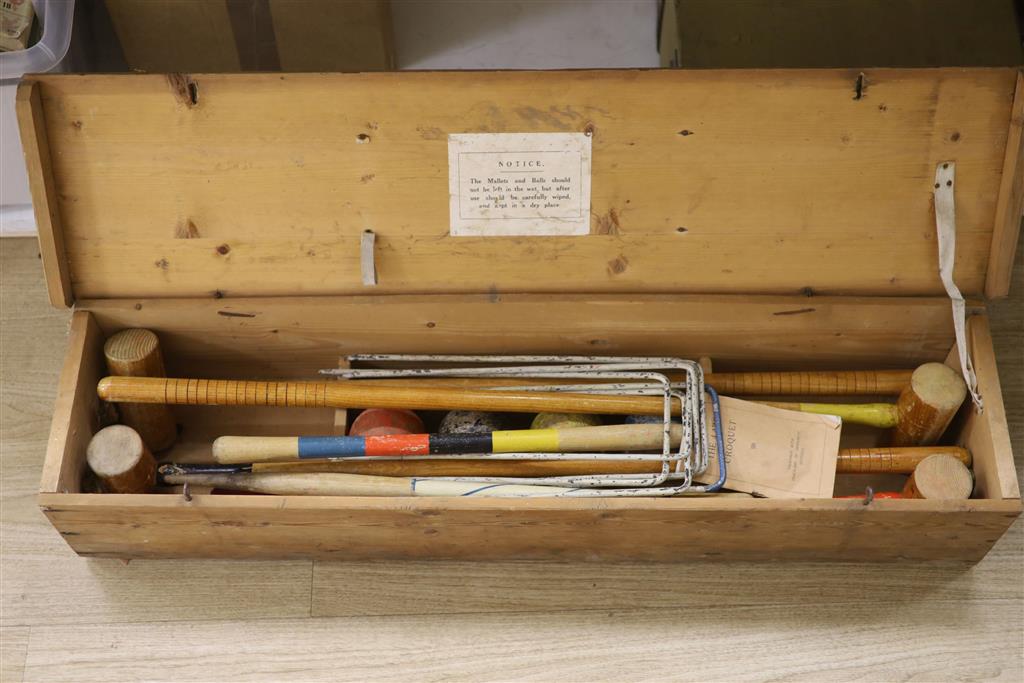 An early 20th century pine cased croquet set